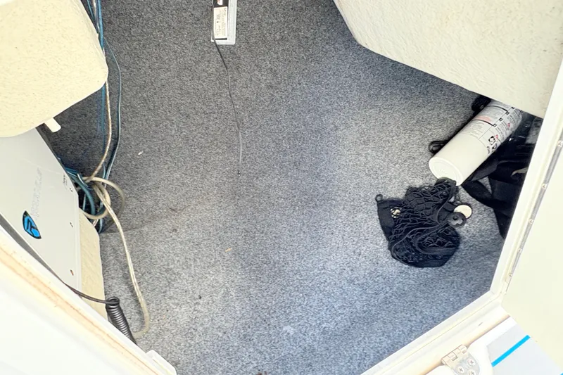Slide: The Image of Interior of a 2014 Yamaha SX190 boat showing carpeted floor and storage items. - 24
