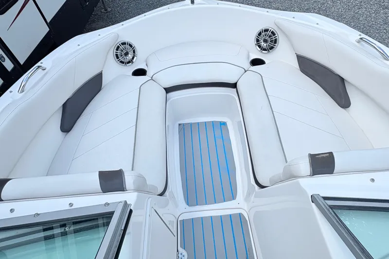 Slide: The Image of 2014 Yamaha SX190 boat interior with white seating and blue-striped flooring. - 25