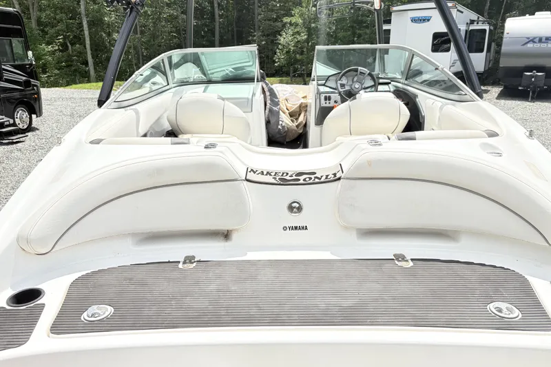 Slide: The Image of 2014 Yamaha SX190 boat with white interior, parked outdoors near RVs. - 5