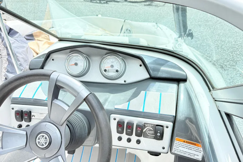 Slide: The Image of 2014 Yamaha SX190 boat dashboard with steering wheel and control panel. - 7