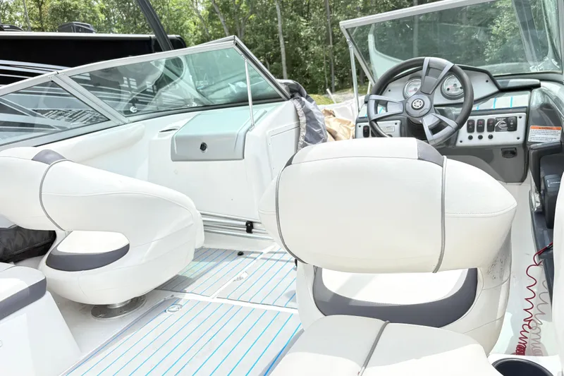 Slide: The Image of 2014 Yamaha SX190 boat interior with white seating and steering console. - 8