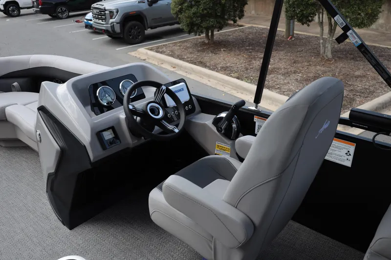 Slide: The Image of 2026 Barletta ARIA 22QC boat interior with steering wheel and dashboard controls. - 12