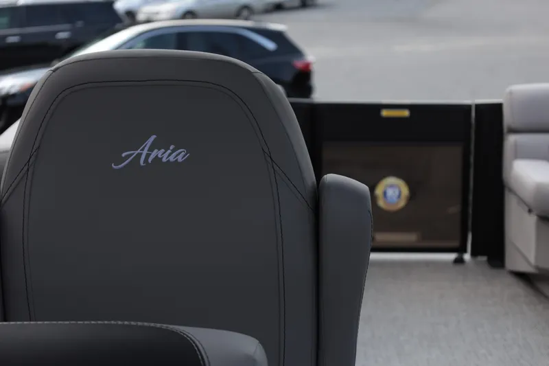 Slide: The Image of Barletta ARIA 22QC 2026 boat seat with "Aria" embroidery, parked cars in background. - 16