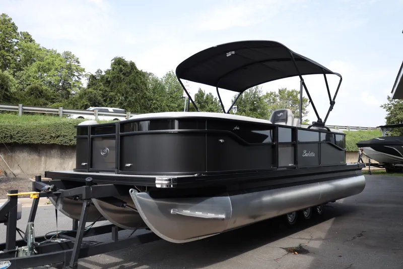 Slide: The Image of 2026 Barletta ARIA 22QC pontoon boat on trailer, parked outdoors. - 3