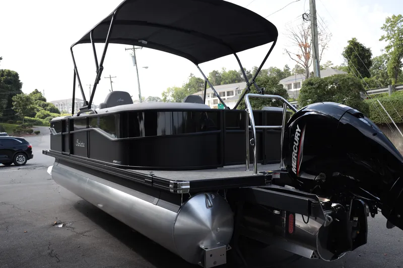 Slide: The Image of 2026 Barletta ARIA 22QC pontoon boat with Mercury engine, parked outdoors. - 5