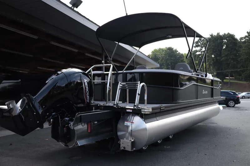 Slide: The Image of 2026 Barletta ARIA 22QC pontoon boat with Mercury outboard motor, parked outdoors. - 6
