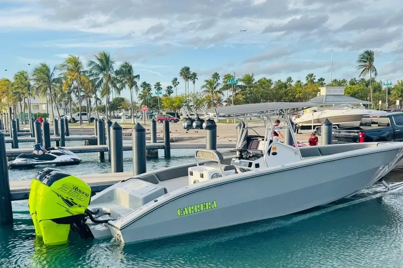 The Image of 2005 Carrera Boats 32 with dual engines, docked near city skyline. - 0