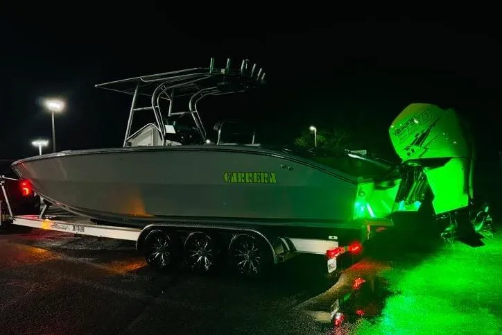 Slide: The Image of Interior of 2005 Carrera Boats 32 with green cooler and speakers. - 10