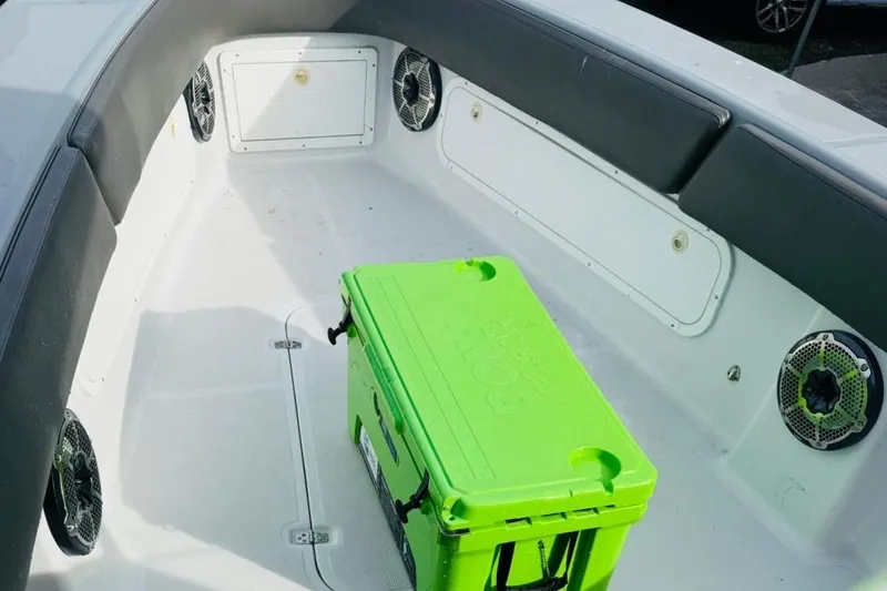 Slide: The Image of 2005 Carrera Boats 32 interior with green cooler, docked near red truck. - 9