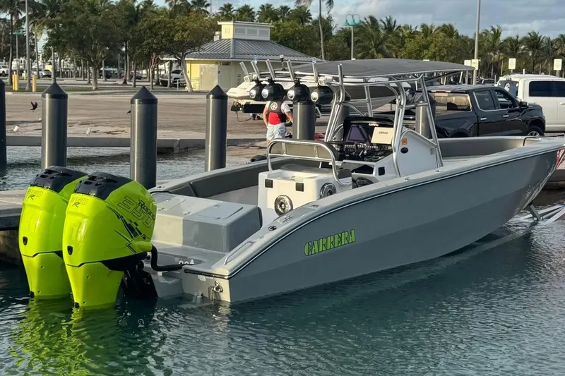 Slide: The Image of 2005 Carrera Boats 32 with green lights on trailer at night. - 11