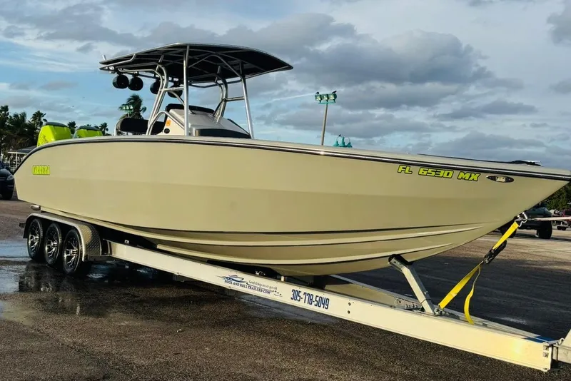 Slide: The Image of 2005 Carrera Boats 32 with twin neon green outboard motors docked at marina. - 12