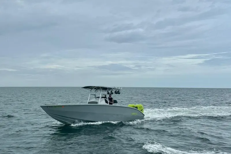Slide: The Image of 2005 Carrera Boats 32 cruising on open water under cloudy skies. - 17