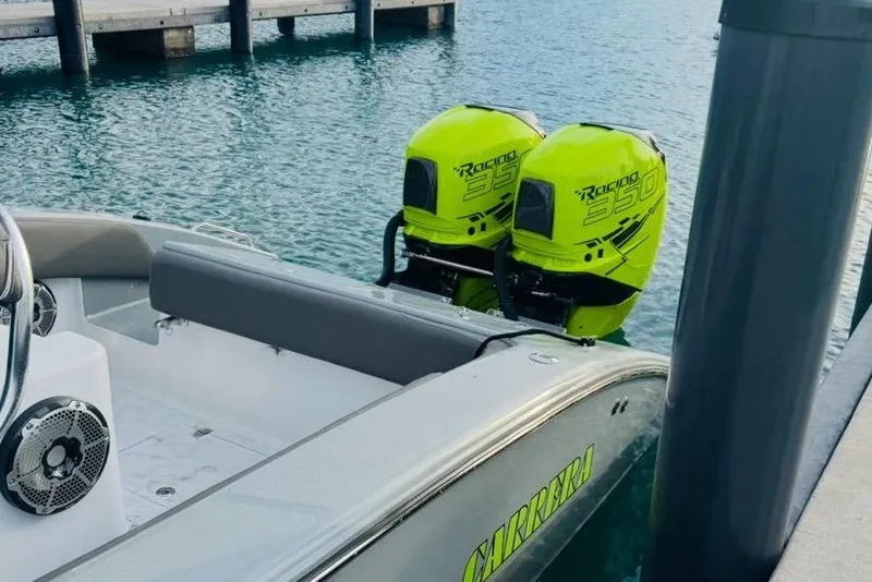 Slide: The Image of 2005 Carrera Boats 32 docked in a serene marina setting. - 2