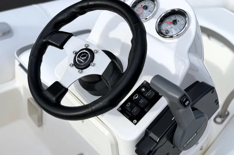 The Image of Steering console of 2003 Zodiac Yachtline 340DL with gauges and controls. - 2
