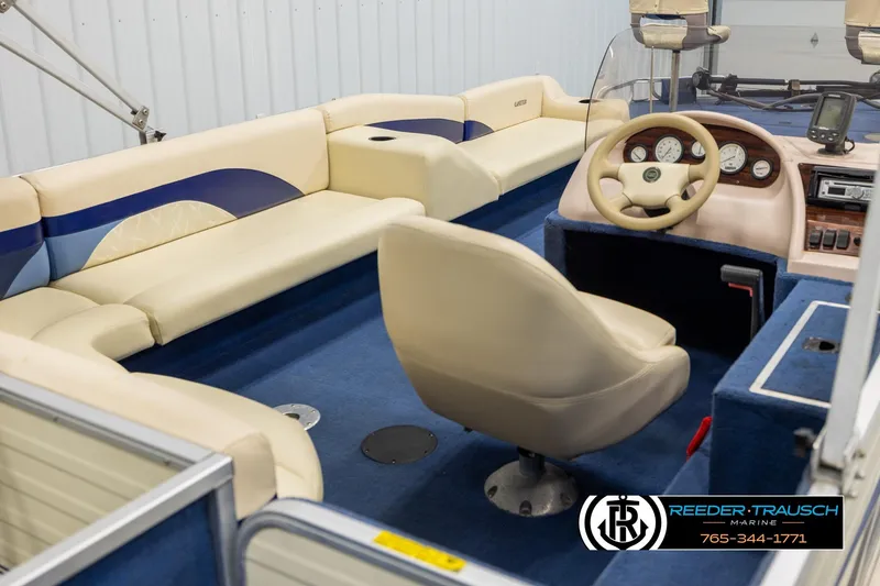Slide: The Image of Interior of a 1998 Lowe LS 2220 boat with beige seating and blue carpet. - 12