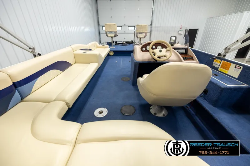 Slide: The Image of Interior of a 1998 Lowe LS 2220 boat with beige seating and blue carpet. - 13