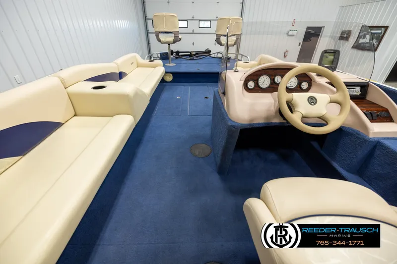 Slide: The Image of Interior of a 1998 Lowe LS 2220 boat with beige seating and blue carpet. - 14