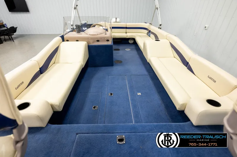 Slide: The Image of Interior of a 1998 Lowe LS 2220 boat with blue carpet and cream seating. - 18