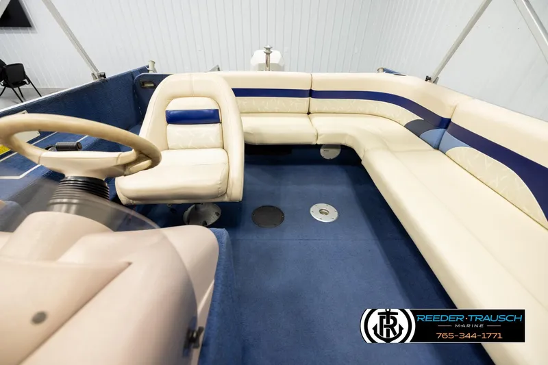 Slide: The Image of 1998 Lowe LS 2220 boat interior with beige seating and blue accents. - 19