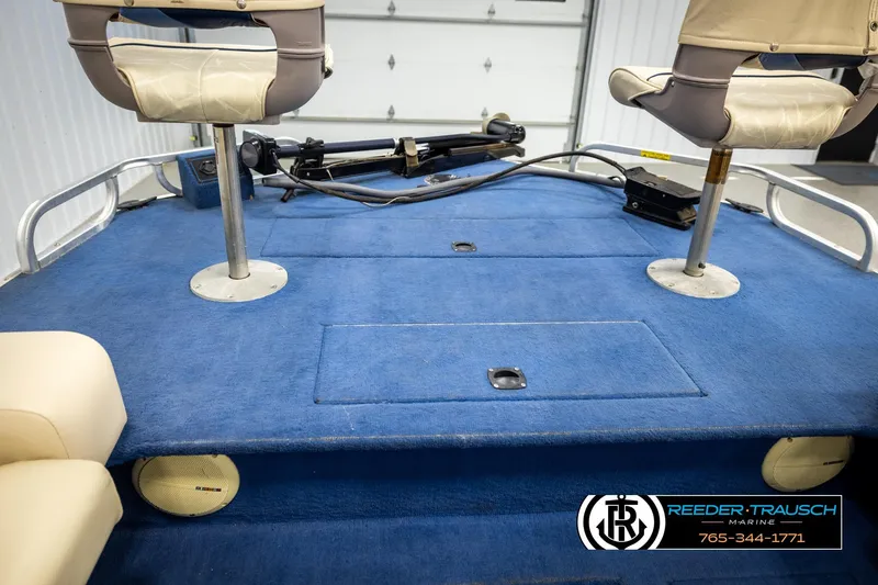 Slide: The Image of 1998 Lowe LS 2220 boat interior with blue carpet and swivel seats. - 20