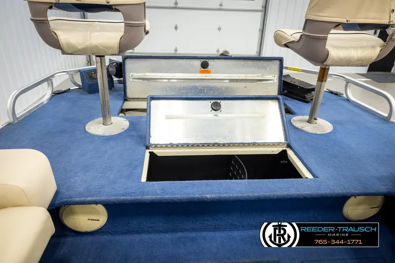 Slide: The Image of Interior of a 1998 Lowe LS 2220 boat with blue carpet and seating. - 21