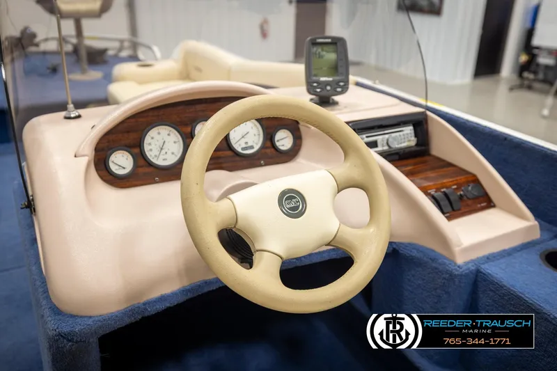 Slide: The Image of 1998 Lowe LS 2220 boat dashboard with steering wheel and gauges, Reeder-Trausch Marine branding. - 25