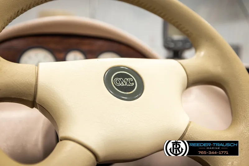 Slide: The Image of Steering wheel of a 1998 Lowe LS 2220 boat with OMC logo, dashboard in background. - 26