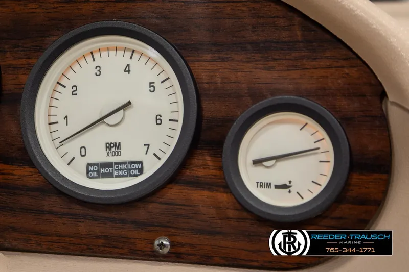 Slide: The Image of Dashboard gauges of a 1998 Lowe LS 2220 boat, featuring RPM and trim indicators. - 28