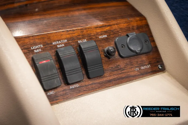 Slide: The Image of Control panel of a 1998 Lowe LS 2220 boat with switches and 12V outlet. - 31