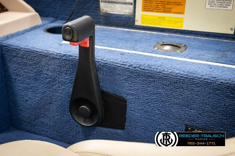 Slide: The Image of Boat throttle control on blue carpeted interior, Lowe LS 2220, 1998 model. - 32