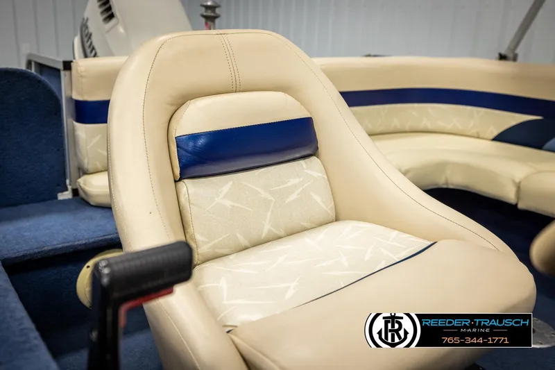 Slide: The Image of 1998 Lowe LS 2220 boat interior with beige and blue seating, Reeder-Trausch Marine logo. - 33