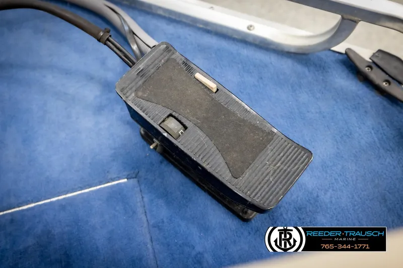 Slide: The Image of Foot pedal on blue carpet in a 1998 Lowe LS 2220 boat. - 39