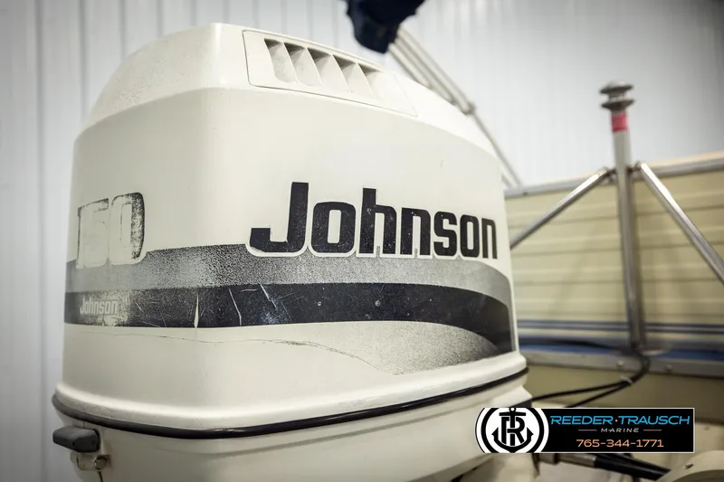 Slide: The Image of 1998 Lowe LS 2220 boat with Johnson 150 outboard motor, Reeder-Trausch Marine logo visible. - 43