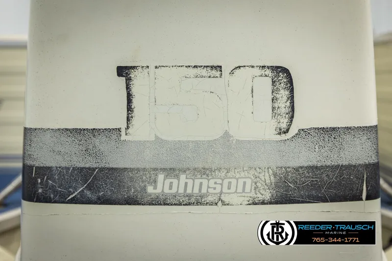 Slide: The Image of Johnson 150 outboard motor on 1998 Lowe LS 2220 boat, Reeder-Trausch Marine logo visible. - 45