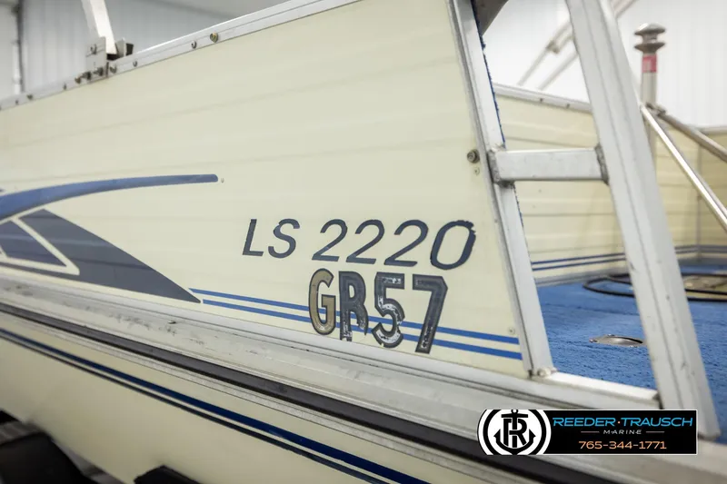 Slide: The Image of 1998 Lowe LS 2220 boat with blue accents and registration number GR57. - 49