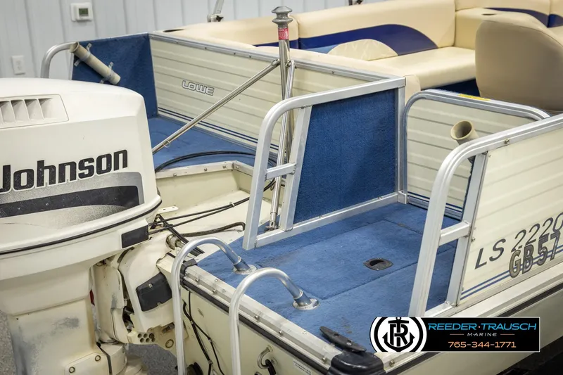 Slide: The Image of 1998 Lowe LS 2220 boat with Johnson outboard motor, blue interior, and Reeder-Trausch Marine logo. - 50