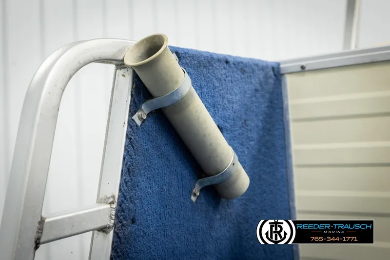 Slide: The Image of 1998 Lowe LS 2220 boat detail with blue carpet and mounted rod holder. - 51