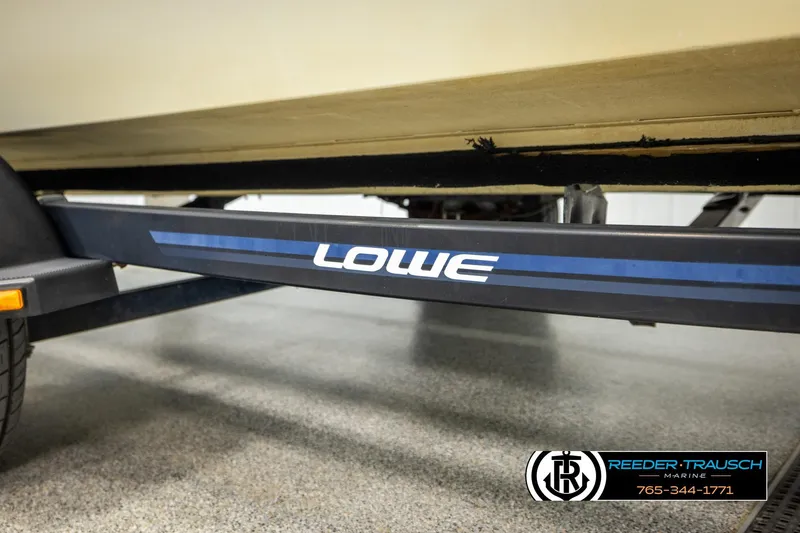 Slide: The Image of Trailer of a 1998 Lowe LS 2220 boat, featuring brand logo and details. - 53