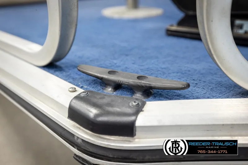 Slide: The Image of Close-up of a 1998 Lowe LS 2220 boat cleat on blue carpeted deck. - 54