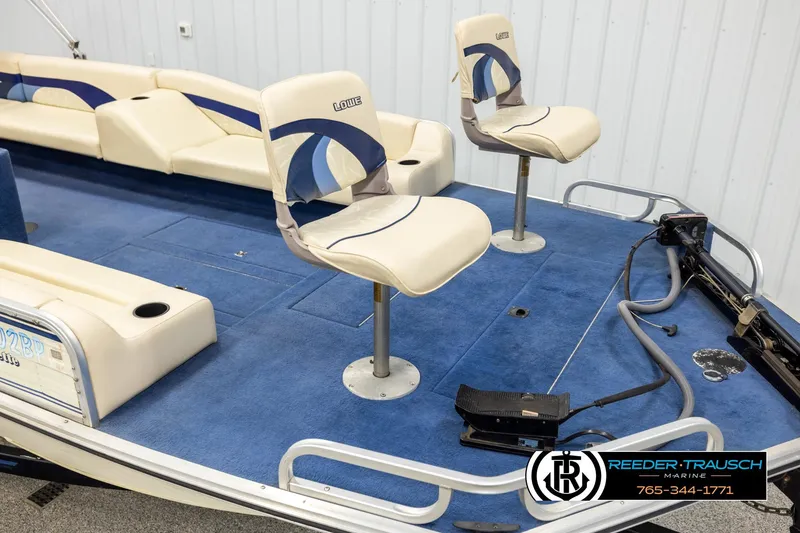 Slide: The Image of 1998 Lowe LS 2220 boat interior with blue carpet and cream seats. - 9