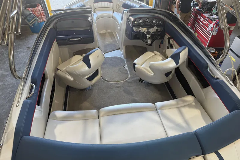 Slide: The Image of Interior of a 2011 FOURWINNS 210 boat with white and blue seating. - 3
