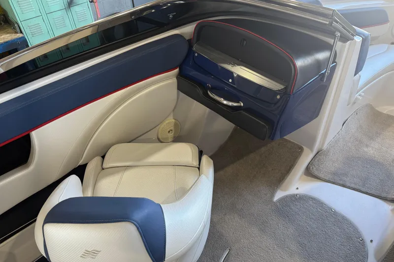 Slide: The Image of Interior of a 2011 FOURWINNS 210 boat with blue and white seating. - 6