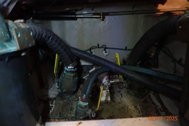 Slide: The Image of Engine room of a 2003 Sea Ray 460 Sundancer with visible hoses and machinery. - 10