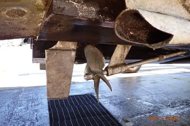 Slide: The Image of 2003 Sea Ray 460 Sundancer propeller and hull detail in dry dock. - 14
