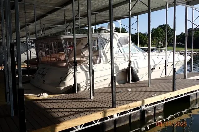 Slide: The Image of 2003 Sea Ray 460 Sundancer docked in a covered marina. - 25
