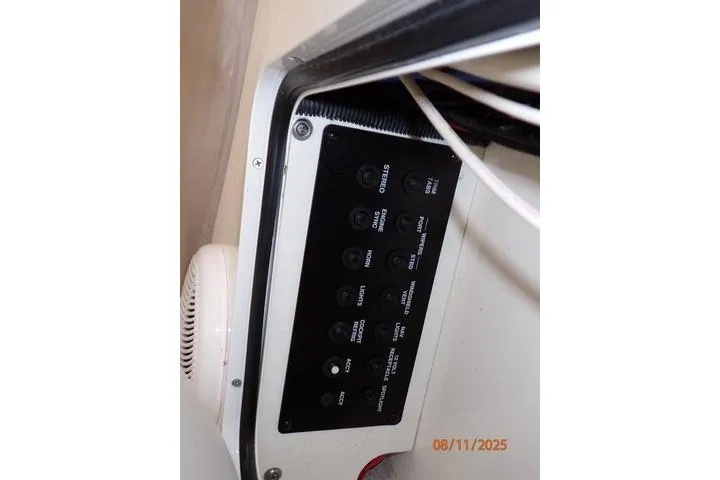 Slide: The Image of Control panel on a 2003 Sea Ray 460 Sundancer boat, featuring various switches. - 28