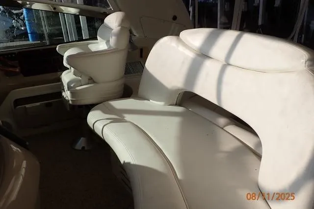 Slide: The Image of Interior seating of 2003 Sea Ray 460 Sundancer yacht, featuring white leather upholstery. - 29