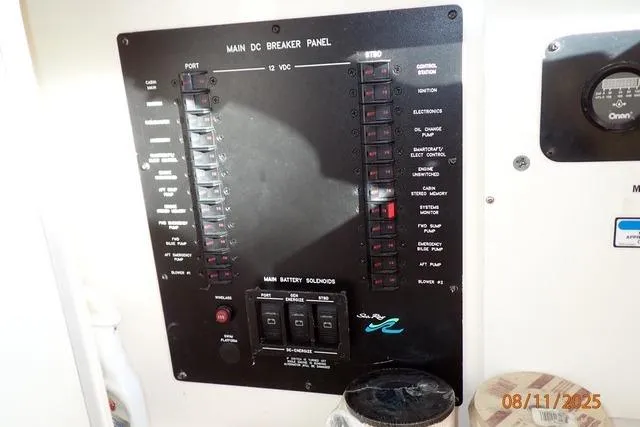 Slide: The Image of Main DC breaker panel on 2003 Sea Ray 460 Sundancer boat, showing switches and controls. - 33