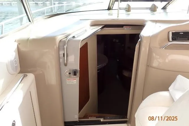 Slide: The Image of 2003 Sea Ray 460 Sundancer cabin entrance with open door, showcasing interior access. - 35
