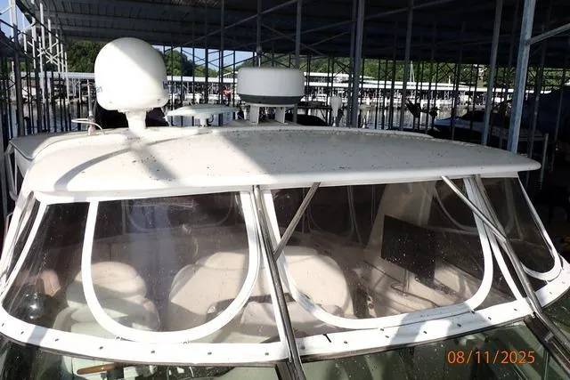 Slide: The Image of 2003 Sea Ray 460 Sundancer yacht docked under a covered marina. - 38